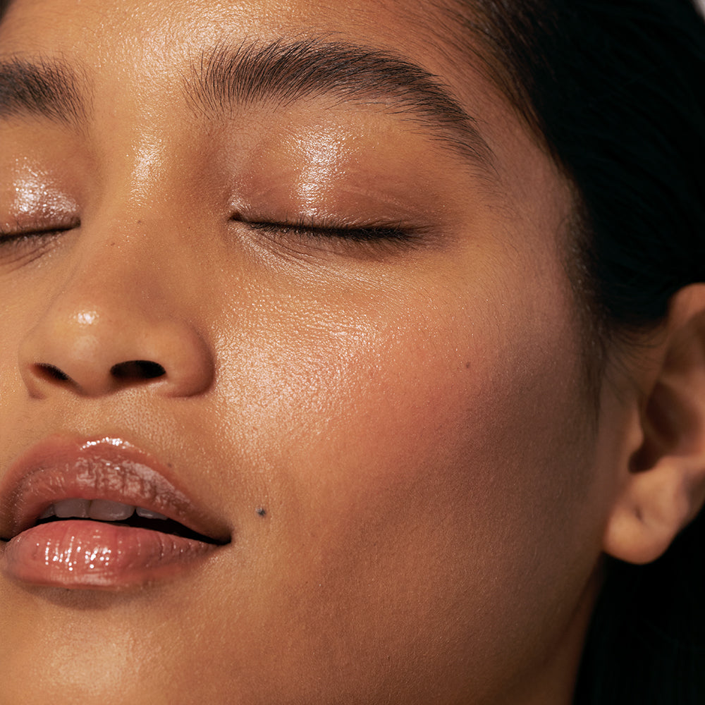 photo of woman's well-moisturized skin focusing on the left side of her face with her eyes closed