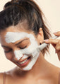 model applying the signature nourishing facial mask