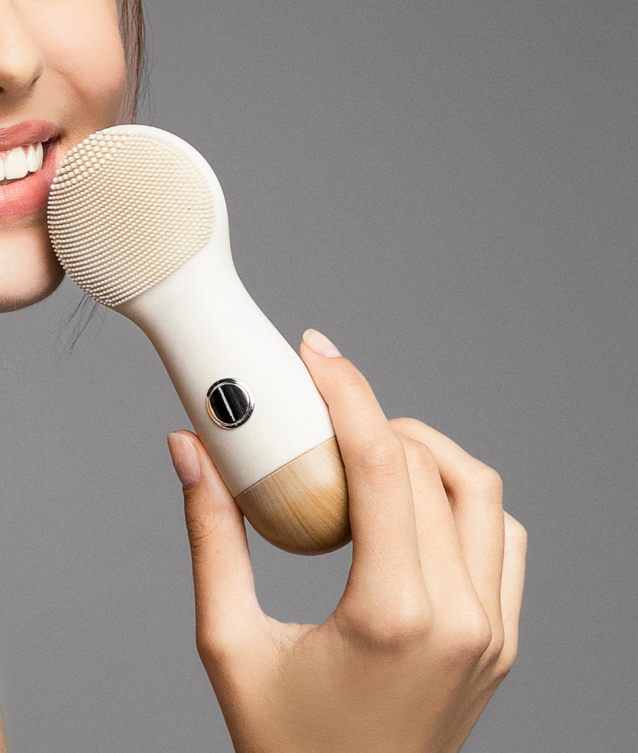 model holding opus luxe cleansing brush