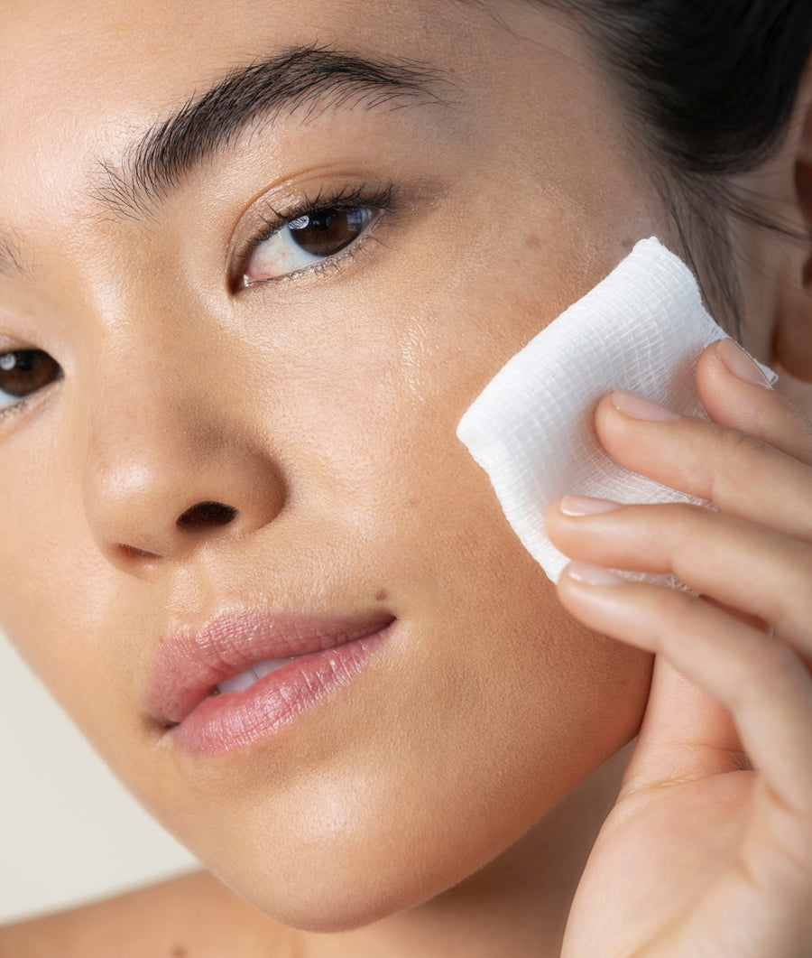 model applying sake toning essence with cotton