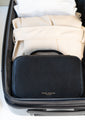shani darden black facial sculpting wand travel case packed in a suitcase with neatly folded clothing